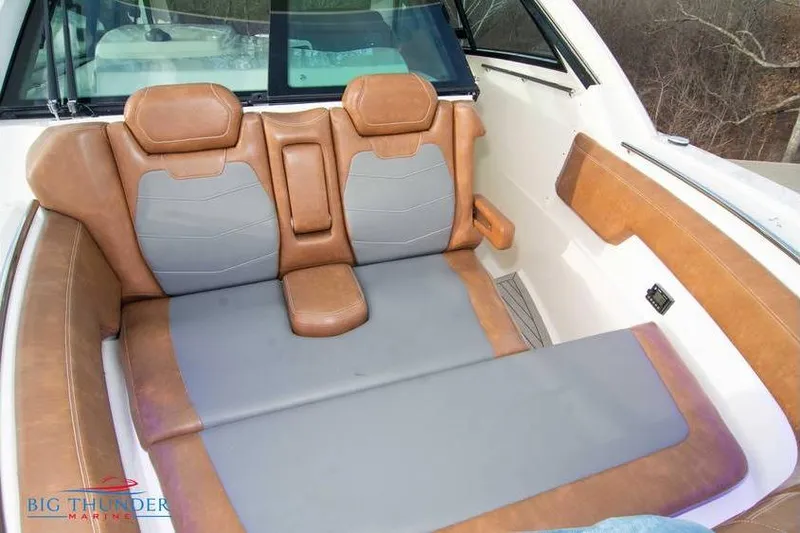 Slide: The Image of 2022 Scout 350 LXZ boat interior with brown and gray seating. - 64