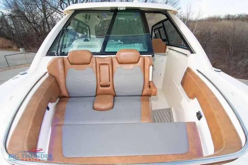 Slide: The Image of 2022 Scout 350 LXZ boat interior with tan and gray seating, outdoor setting. - 65