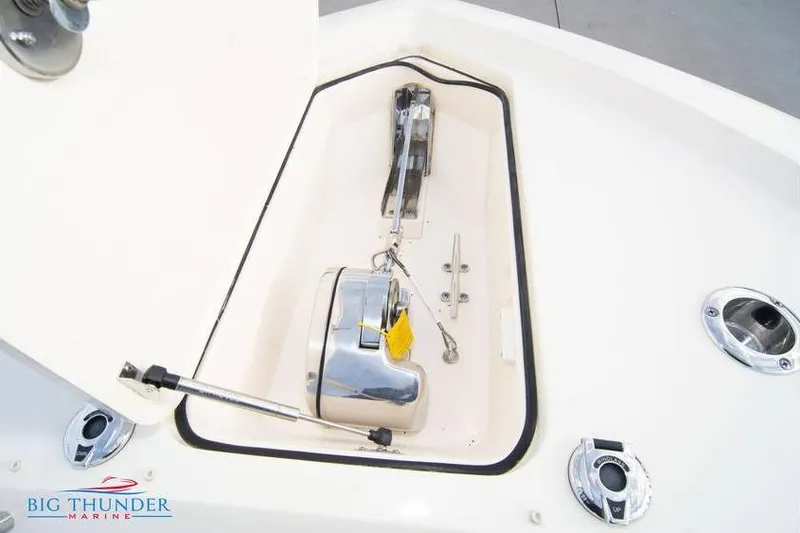 Slide: The Image of 2022 Scout 350 LXZ boat anchor compartment with chrome fittings and Big Thunder Marine logo. - 67
