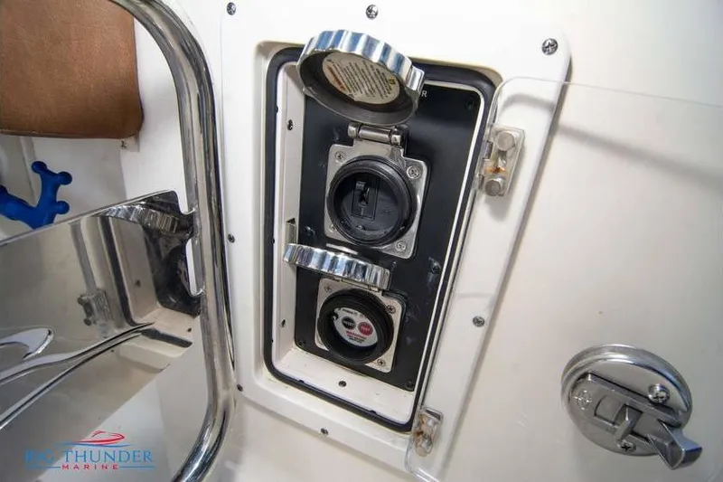 Slide: The Image of 2022 Scout 350 LXZ boat electrical panel with open access cover. - 69