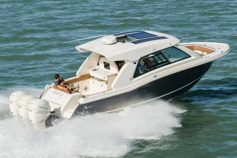 Slide: The Image of Manufacturer Provided Image: 2022 Scout 350 LXZ boat cruising on the water. - 75