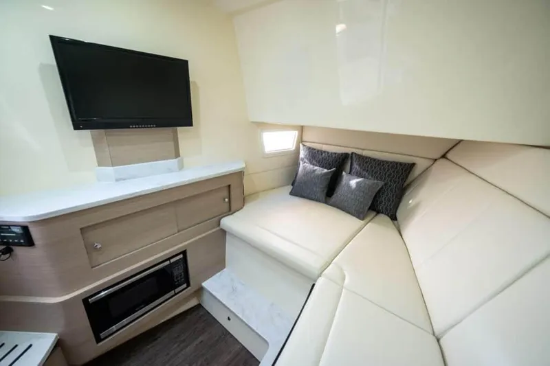 Slide: The Image of Manufacturer Provided Image: 2022 Scout 350 LXZ cabin interior with TV, microwave, and cozy seating. - 78