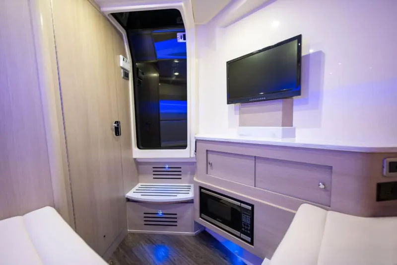Slide: The Image of Manufacturer Provided Image: Modern interior of 2022 Scout 350 LXZ boat with TV and microwave. - 79