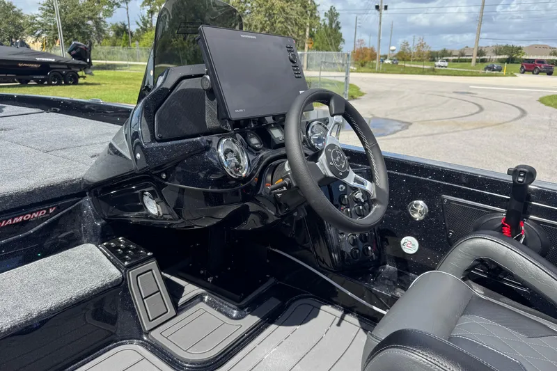 Slide: The Image of 2026 Phoenix 921 Elite X boat interior with modern dashboard and steering wheel. - 17