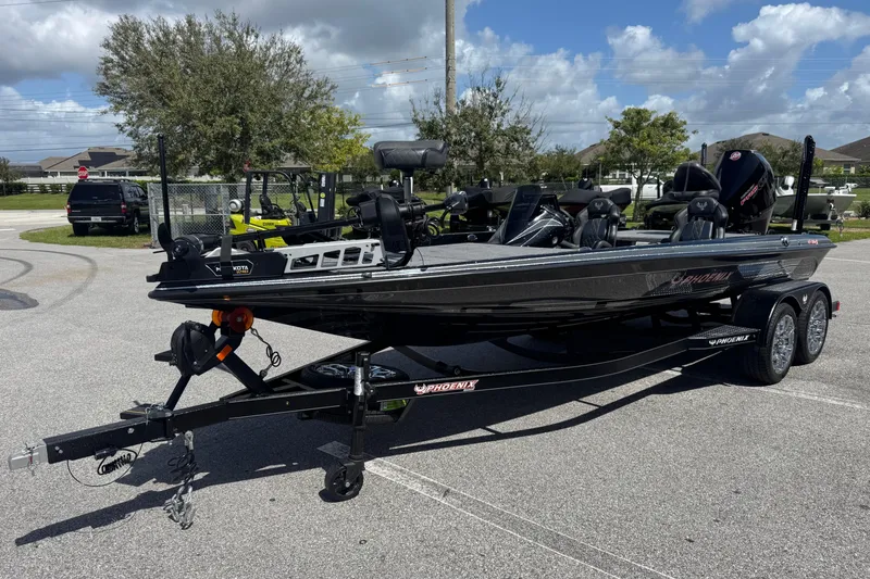 Slide: The Image of 2026 Phoenix 921 Elite X boat on trailer, parked outdoors under a clear sky. - 3