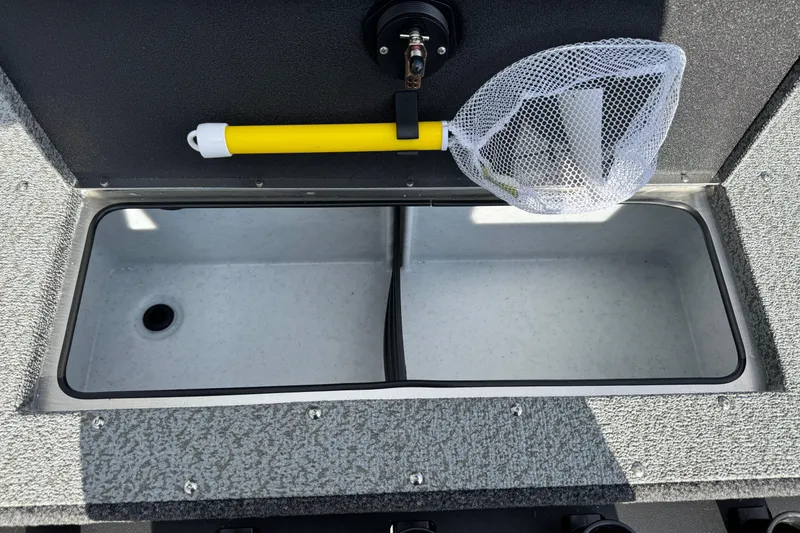 Slide: The Image of 2026 Lund 1875 Fisherman boat livewell with a yellow-handled fishing net. - 7