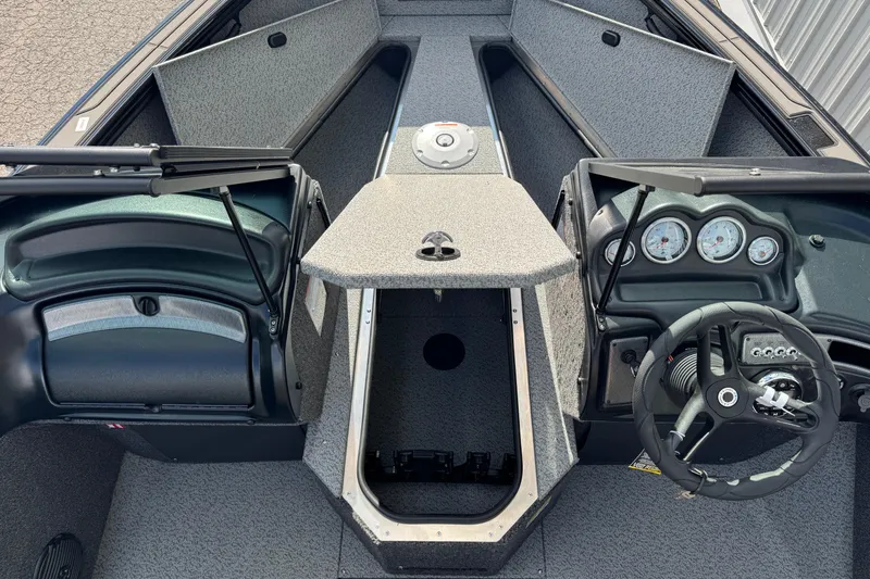 Slide: The Image of 2026 Lund 1875 Fisherman boat interior with steering wheel and dashboard gauges. - 9