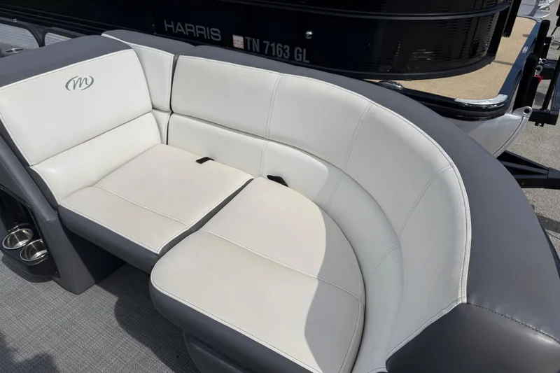 Slide: The Image of 2021 Manitou 22 Aurora LE Standard boat with white cushioned seating and cup holders. - 11