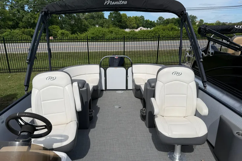 Slide: The Image of 2021 Manitou 22 Aurora LE Standard pontoon boat with white seating and canopy. - 12