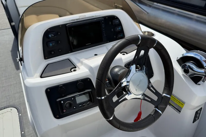 Slide: The Image of Steering console of 2021 Manitou 22 Aurora LE Standard boat with modern controls. - 14
