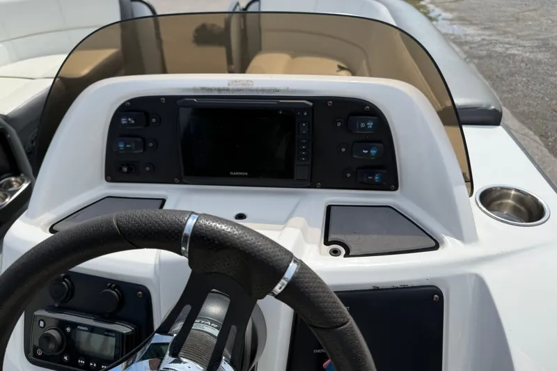 Slide: The Image of 2021 Manitou 22 Aurora LE Standard dashboard with Garmin display and steering wheel. - 15