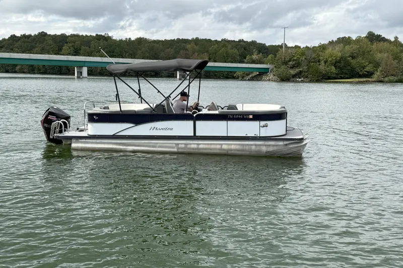 Slide: The Image of 2021 Manitou 22 Aurora LE Standard pontoon boat on a scenic lake. - 4