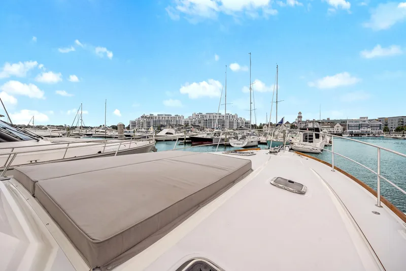 Slide: The Image of 2018 Sabre 48 Salon Express yacht docked in a marina with clear blue skies. - 12