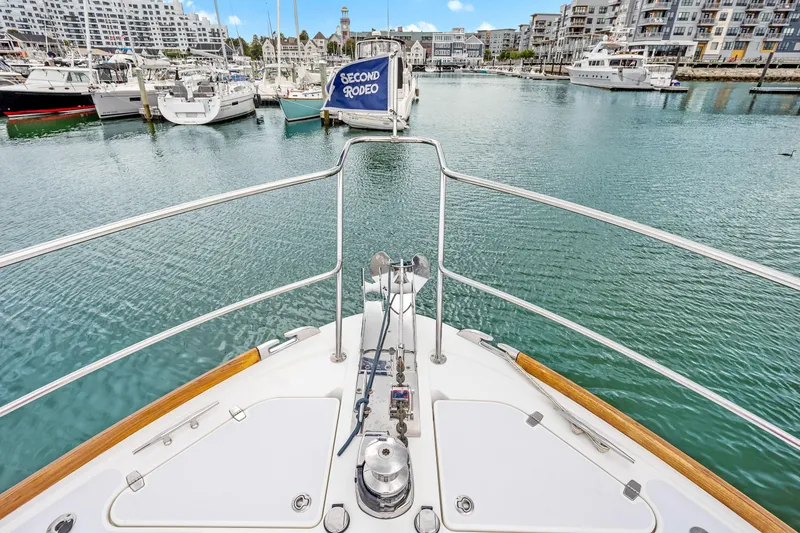 Slide: The Image of Bow view of 2018 Sabre 48 Salon Express in a marina setting. - 13