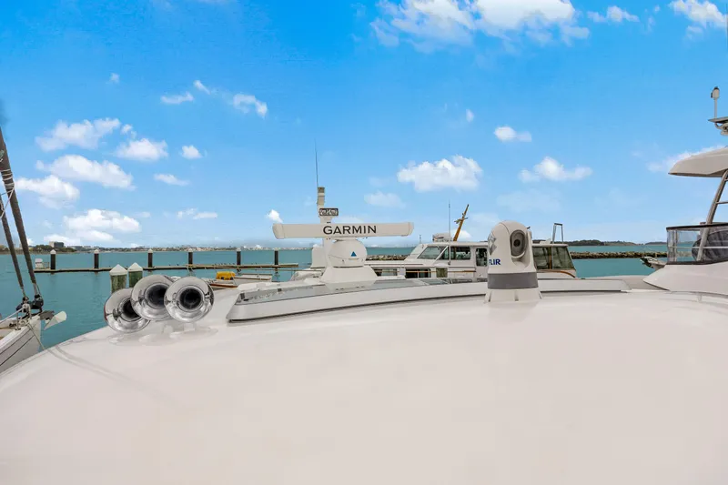 Slide: The Image of 2018 Sabre 48 Salon Express yacht with Garmin equipment, docked under a clear blue sky. - 14