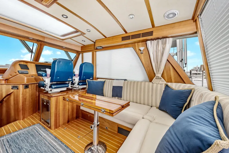 Slide: The Image of Luxurious interior of 2018 Sabre 48 Salon Express yacht with plush seating and elegant wood finishes. - 17