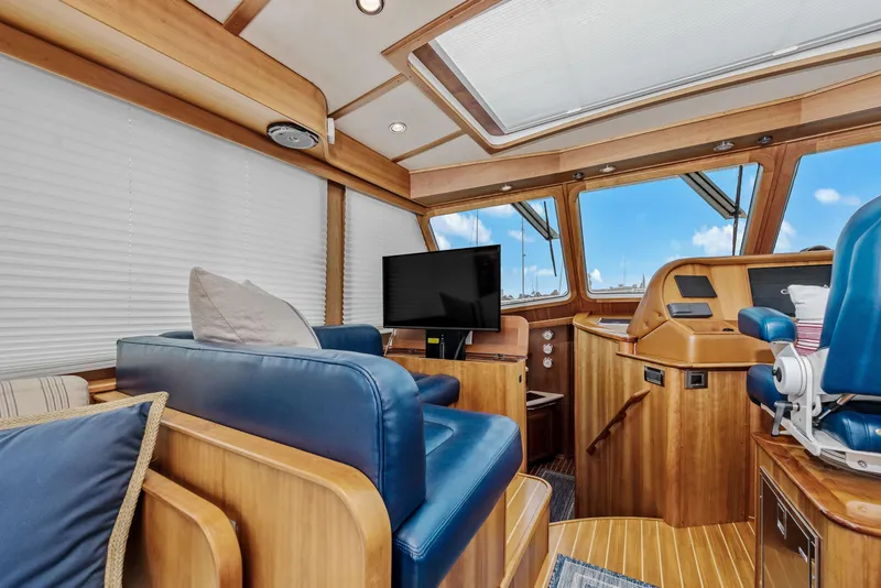 Slide: The Image of Interior of 2018 Sabre 48 Salon Express yacht with blue seating and wooden accents. - 20
