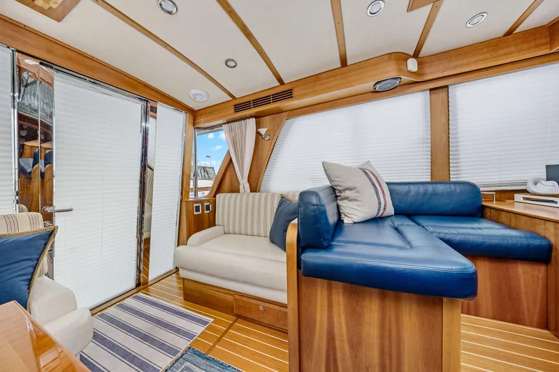 Slide: The Image of Luxurious interior of 2018 Sabre 48 Salon Express yacht with plush seating and wooden accents. - 21