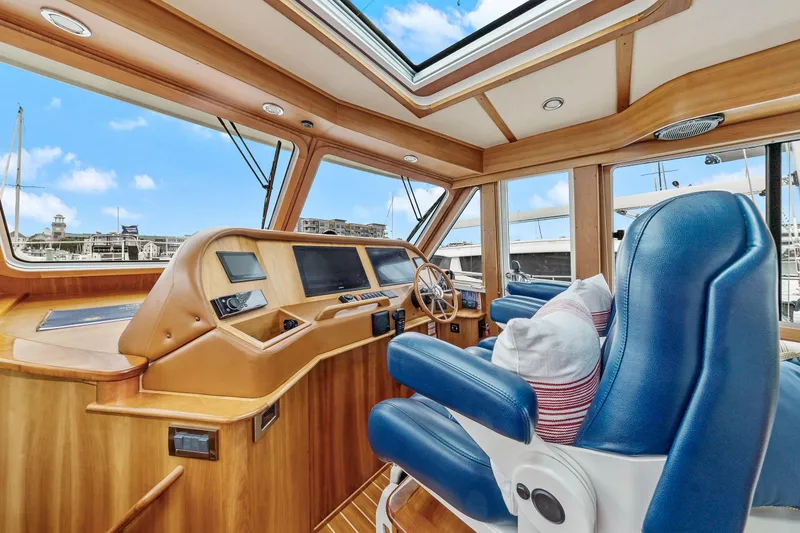 Slide: The Image of Interior of 2018 Sabre 48 Salon Express yacht with blue seats and wooden dashboard. - 25