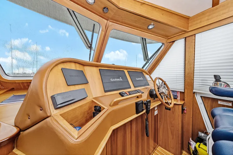 Slide: The Image of 2018 Sabre 48 Salon Express helm with Garmin navigation and wooden interior. - 26