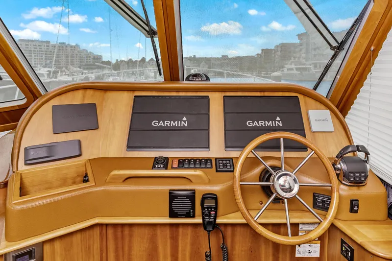 Slide: The Image of 2018 Sabre 48 Salon Express helm with Garmin navigation and wooden steering wheel. - 27