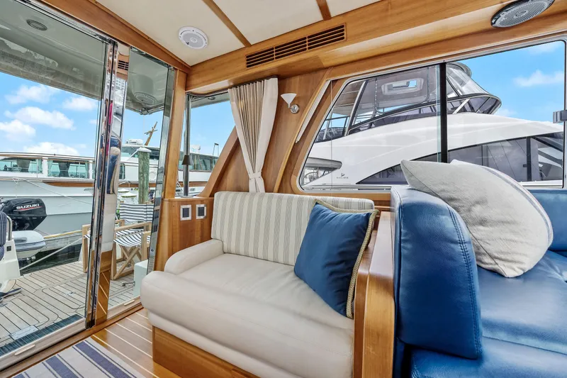 Slide: The Image of Interior of 2018 Sabre 48 Salon Express yacht with plush seating and marina view. - 32