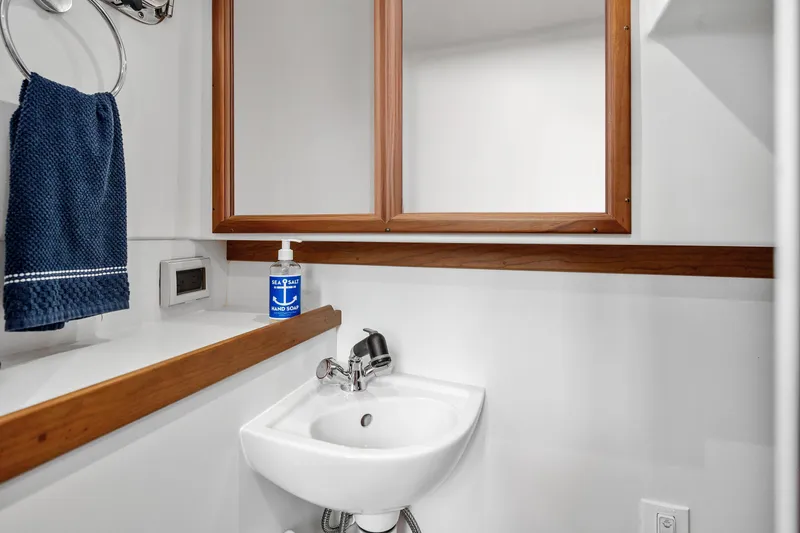 Slide: The Image of 2018 Sabre 48 Salon Express bathroom with sink, mirror, and towel. - 37