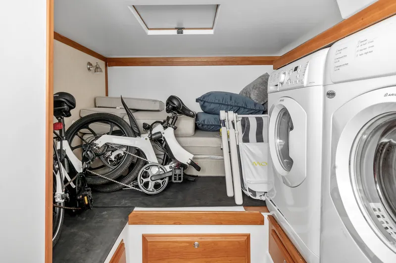 Slide: The Image of Laundry area with folding bike and sofa in 2018 Sabre 48 Salon Express. - 38