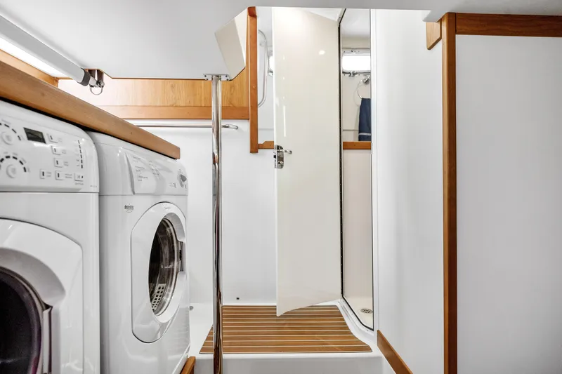 Slide: The Image of Laundry area with washer, dryer, and shower on 2018 Sabre 48 Salon Express yacht. - 39
