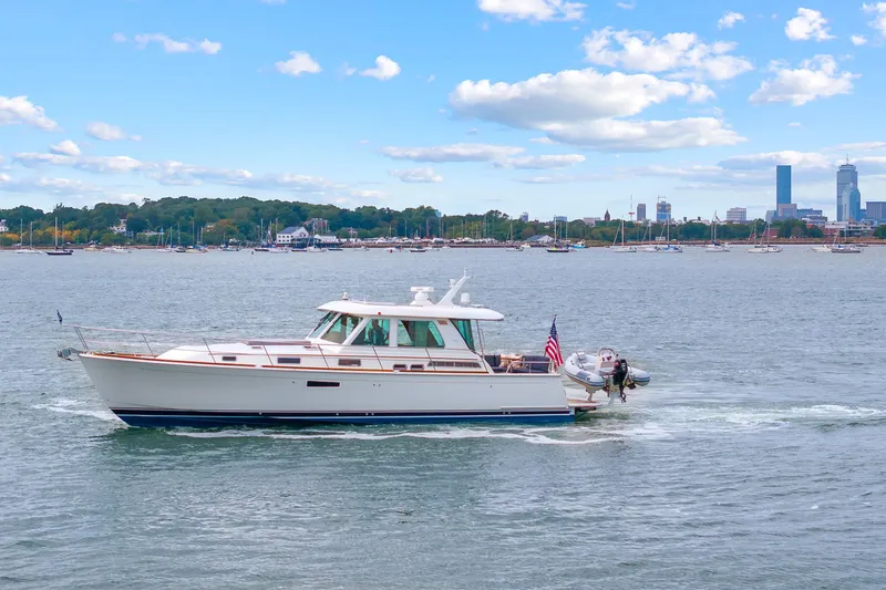 Slide: The Image of 2018 Sabre 48 Salon Express yacht cruising near city skyline on a sunny day. - 4