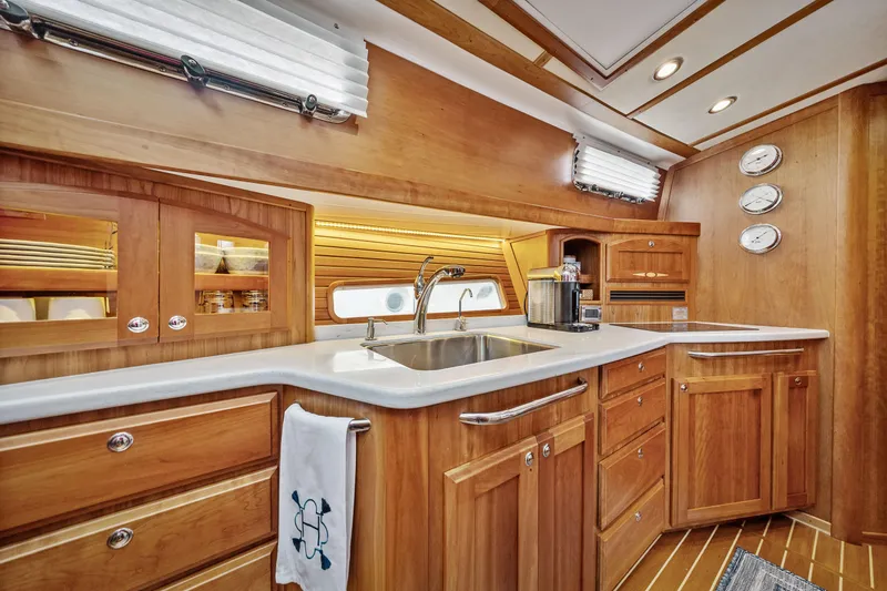 Slide: The Image of Luxurious 2018 Sabre 48 Salon Express yacht kitchen with wood cabinetry and modern amenities. - 42