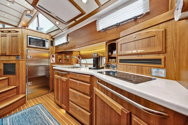 Slide: The Image of Luxurious 2018 Sabre 48 Salon Express yacht interior with modern kitchen and wooden cabinetry. - 43