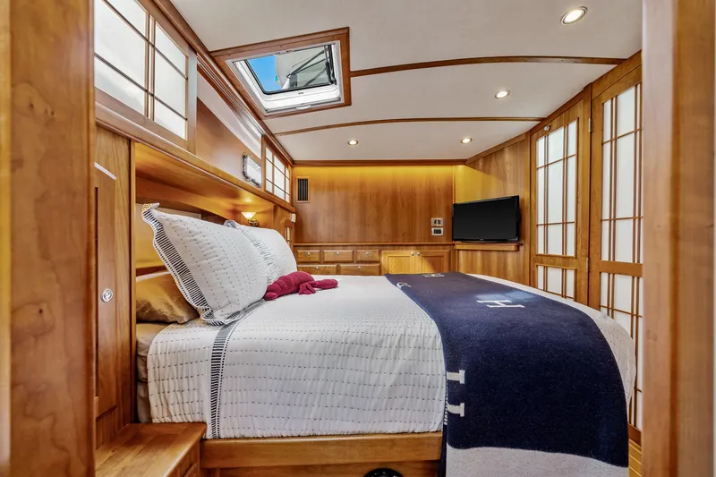 Slide: The Image of Luxurious 2018 Sabre 48 Salon Express bedroom with elegant wood paneling and skylight. - 47