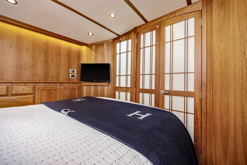 Slide: The Image of Luxurious 2018 Sabre 48 Salon Express cabin with wood paneling and modern amenities. - 49