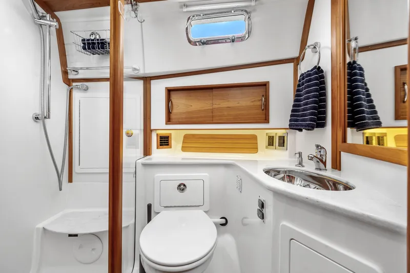 Slide: The Image of Luxurious bathroom in 2018 Sabre 48 Salon Express yacht with wood accents and modern fixtures. - 55