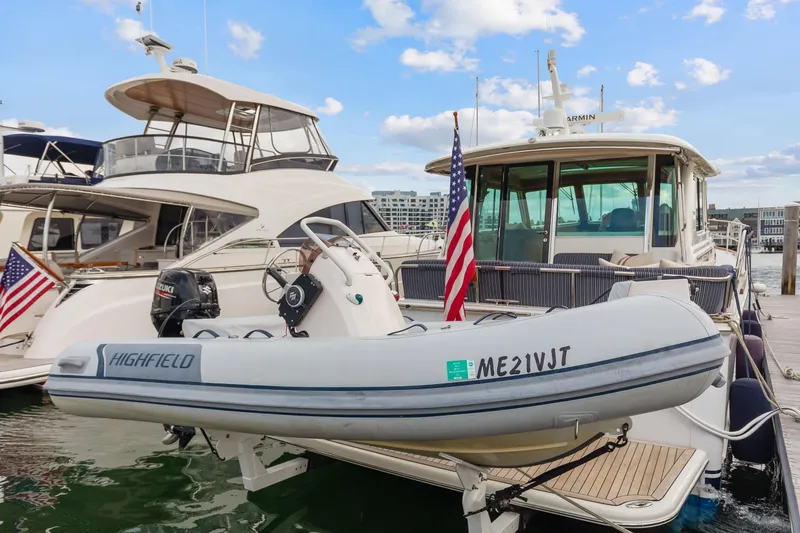 Slide: The Image of 2018 Sabre 48 Salon Express yacht docked with inflatable boat, American flag displayed. - 57