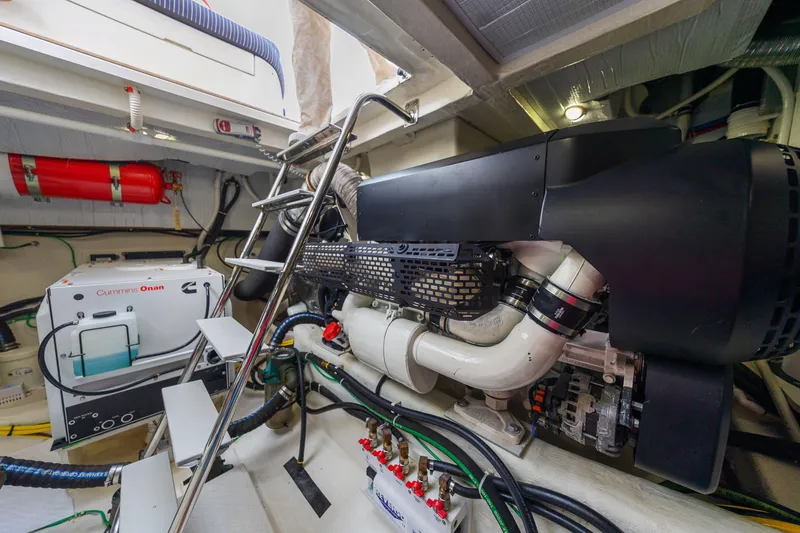 Slide: The Image of Engine room of 2018 Sabre 48 Salon Express with Cummins Onan generator and fire extinguisher. - 63