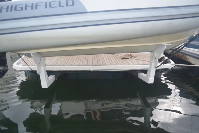 Slide: The Image of 2018 Sabre 48 Salon Express yacht with a Highfield tender on hydraulic platform. - 65