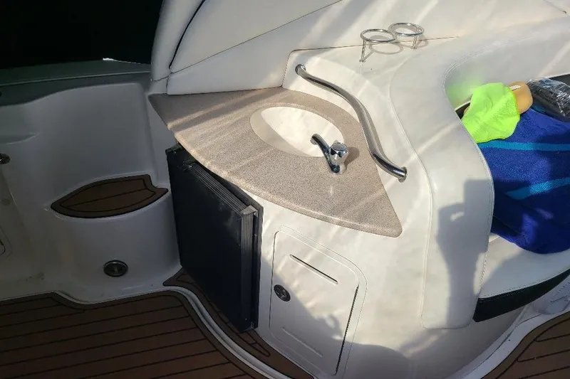 Slide: The Image of 2006 Sea Ray 320 Sundancer boat interior with sink and storage area. - 10