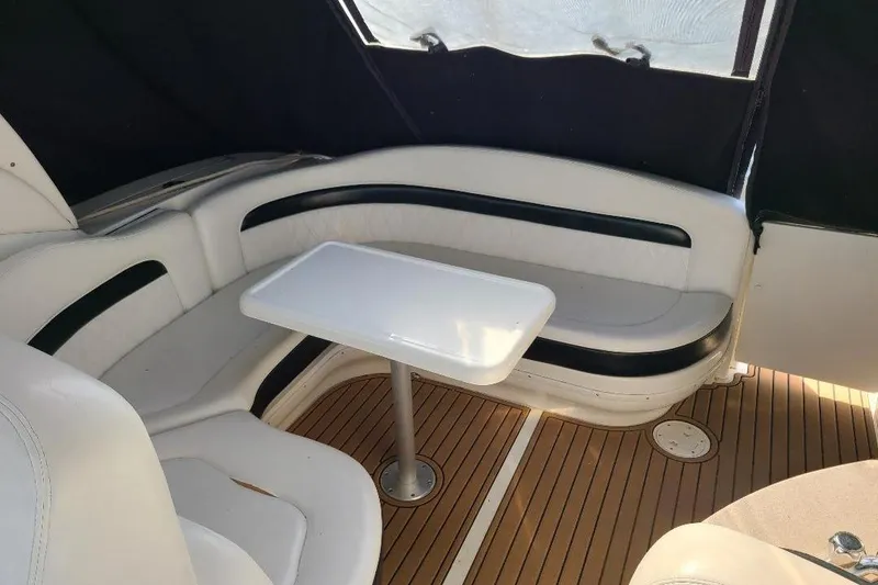 Slide: The Image of Interior of 2006 Sea Ray 320 Sundancer with white seating and wooden flooring. - 11