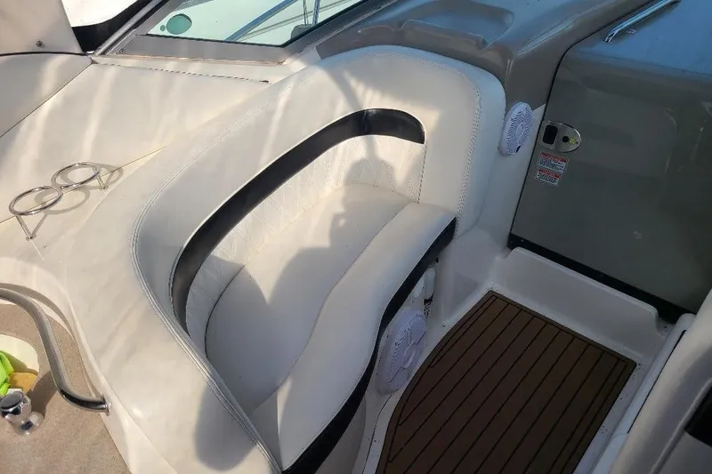 Slide: The Image of 2006 Sea Ray 320 Sundancer interior with white seating and cup holders. - 13