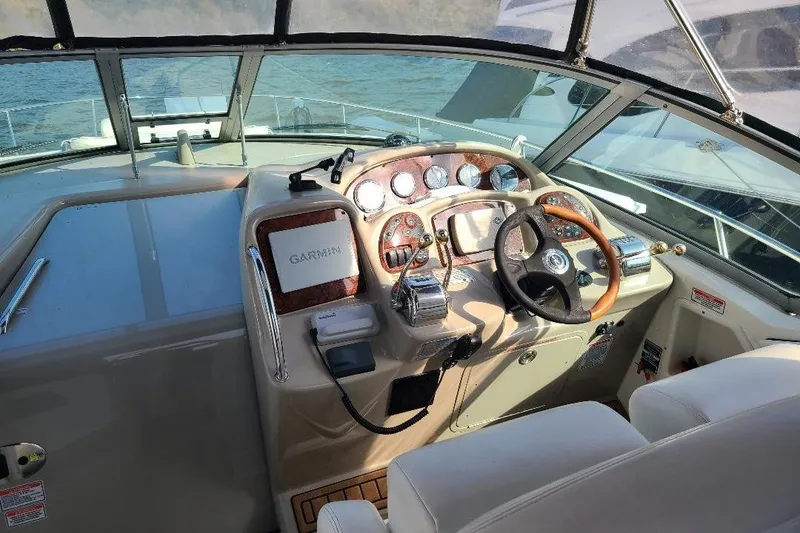 Slide: The Image of Cockpit of 2006 Sea Ray 320 Sundancer with Garmin navigation system and steering wheel. - 14