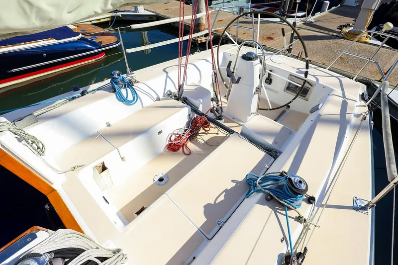 Slide: The Image of 2000 J Boats J/105 sailboat cockpit with steering wheel and rigging at dock. - 13