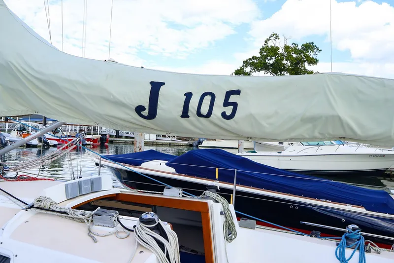 Slide: The Image of 2000 J Boats J/105 sailboat docked, featuring covered sails and marina background. - 15