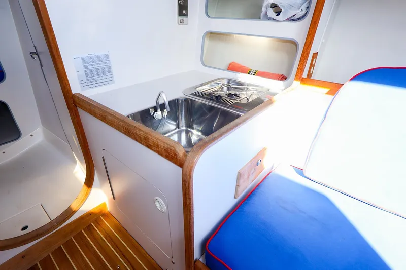 Slide: The Image of Interior of 2000 J Boats J/105 sailboat with sink and seating area. - 24
