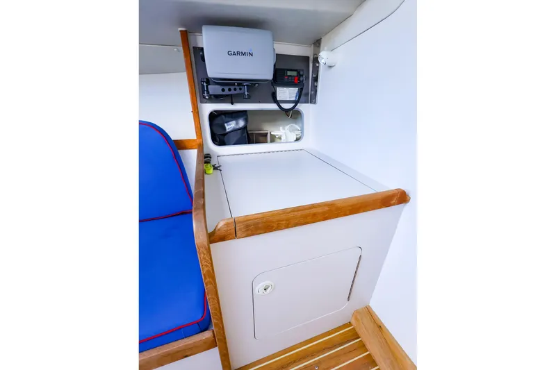 Slide: The Image of Interior of a 2000 J Boats J/105 featuring navigation equipment and blue seating. - 25