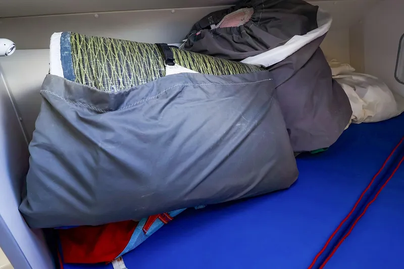 Slide: The Image of Sail storage area inside a 2000 J Boats J/105, featuring neatly packed sails. - 27