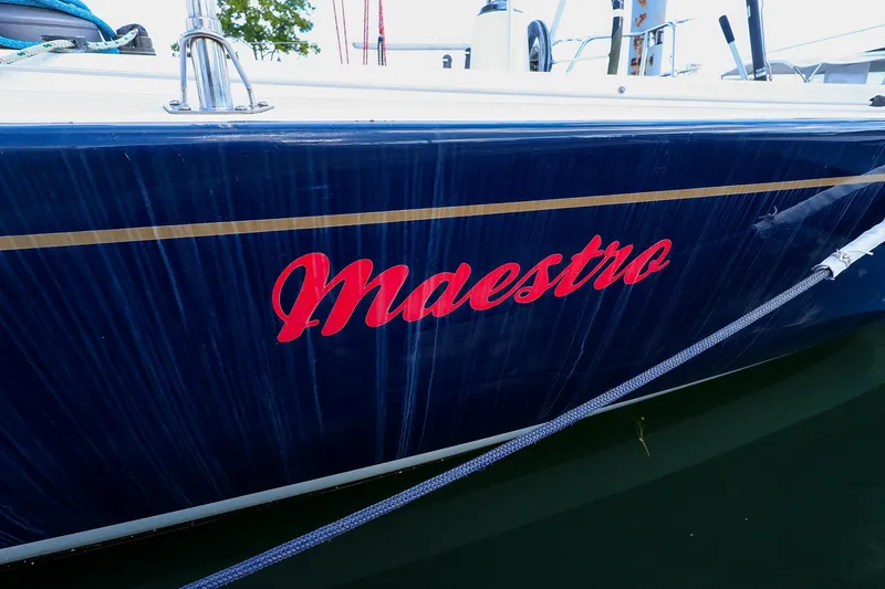 Slide: The Image of 2000 J Boats J/105 sailboat named Maestro with blue hull and red lettering. - 4