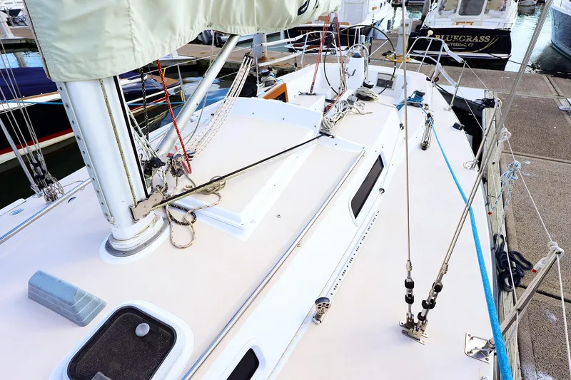 Slide: The Image of Deck view of a 2000 J Boats J/105 sailboat docked at a marina. - 5