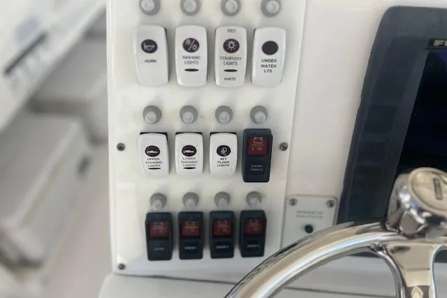 Slide: The Image of Control panel of a 2011 Everglades 350LX boat with various switches and buttons. - 16
